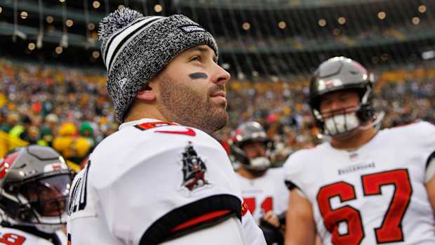 Baker Mayfield looks up wearing a winter hat